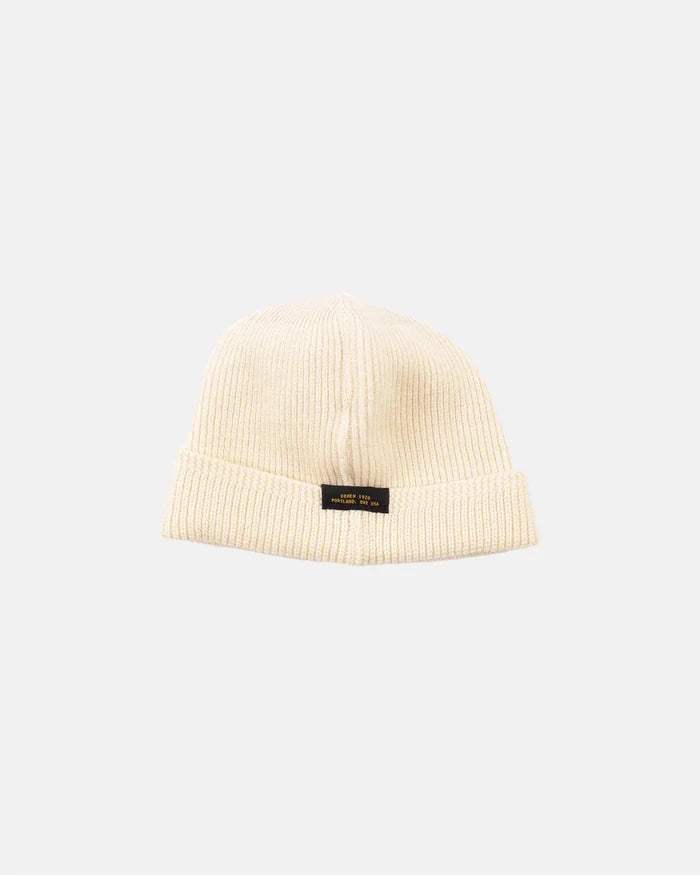 Natural color ribbed wool knit watch cap with folded brim and Dehen 1920 label