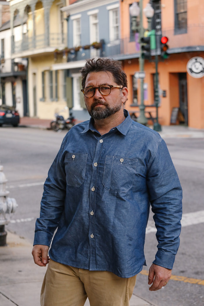 Man wearing a blue denim shirt on a city street