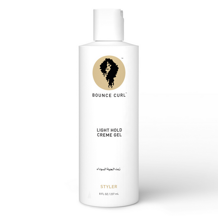 A white bottle of Bounce Curl Light Hold Creme Gel with a product label that includes the brand name and an image of a curl. The bottle is designed for hair styling.