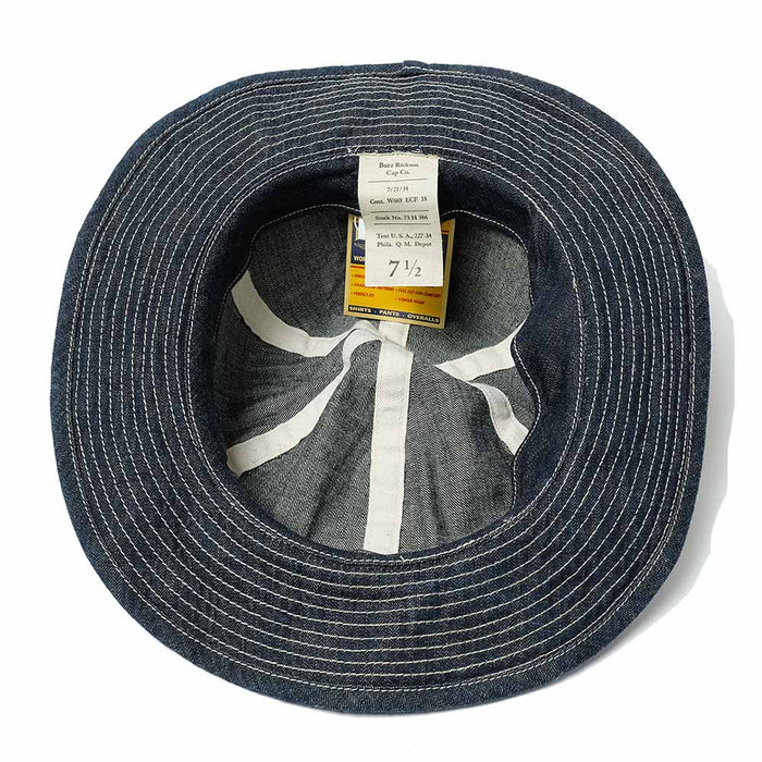 Blue denim hat with a label inside on a white background