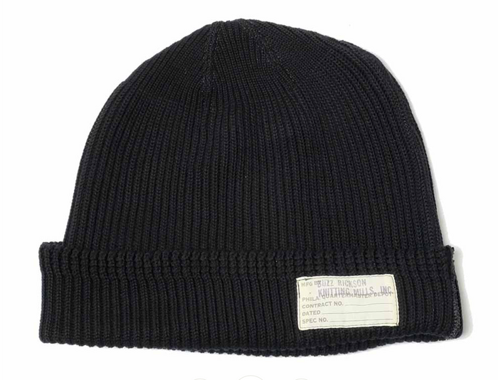 Black knit beanie with a label on a white background