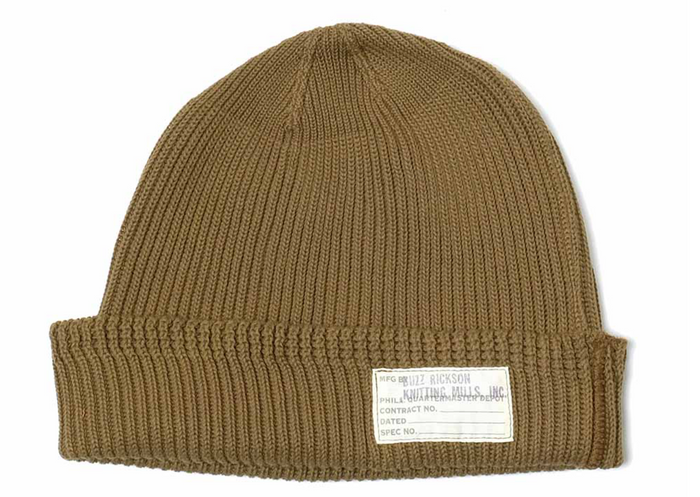 Brown knit beanie with a label on a white background