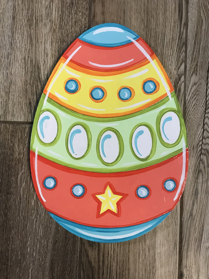 Colorful easter egg with blue, red, yellow stripes and dots