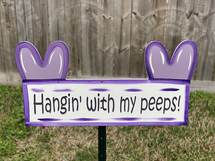 Hangin' With my peeps! purple yard sign in a backyard with Peep ears on either side