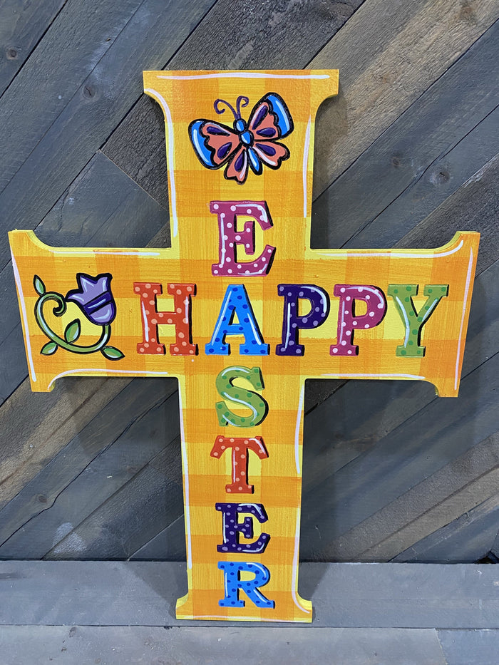A cross-shaped Happy Easter blank sign with various colorful letters on a yellow background, designed for DIY painting projects.