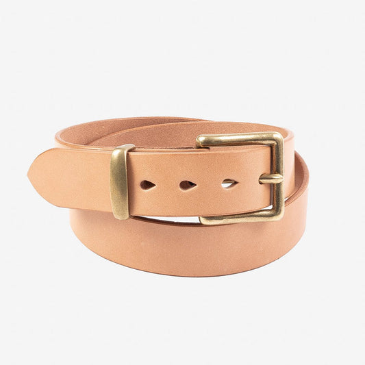 Natural tan leather belt with brass rectangular buckle, rolled up against white background