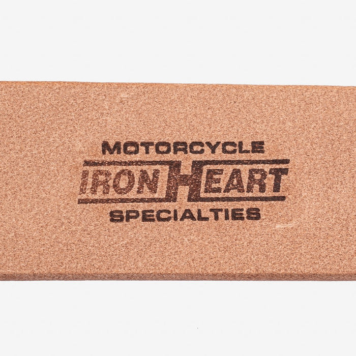 Close-up of a brown leather label with the stamped text 'Motorcycle Iron Heart Specialties'