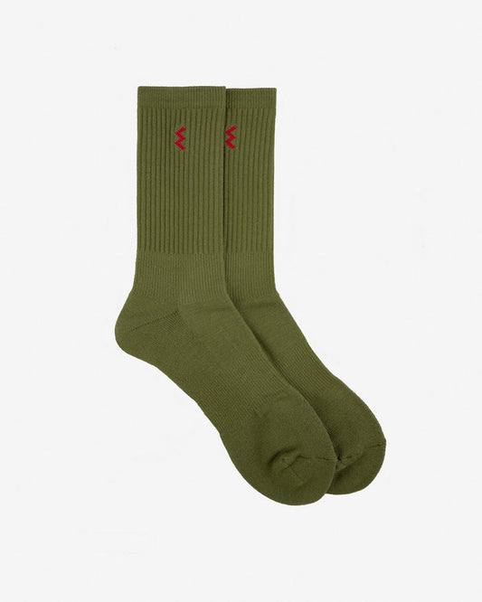 Pair of olive green ribbed crew socks with small red zigzag logo on each cuff