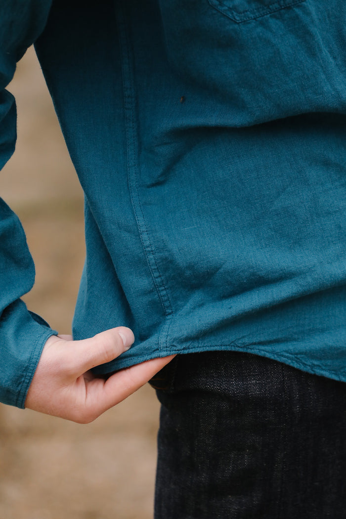 Person wearing a blue jacket with a blurred background