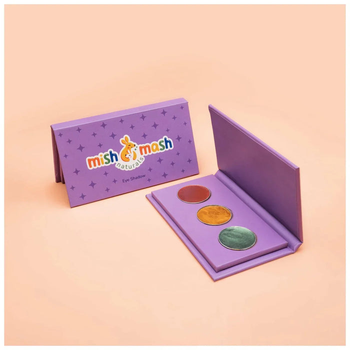 Purple eye shadow palette with three colors and 'mish mash' packaging on a peach background