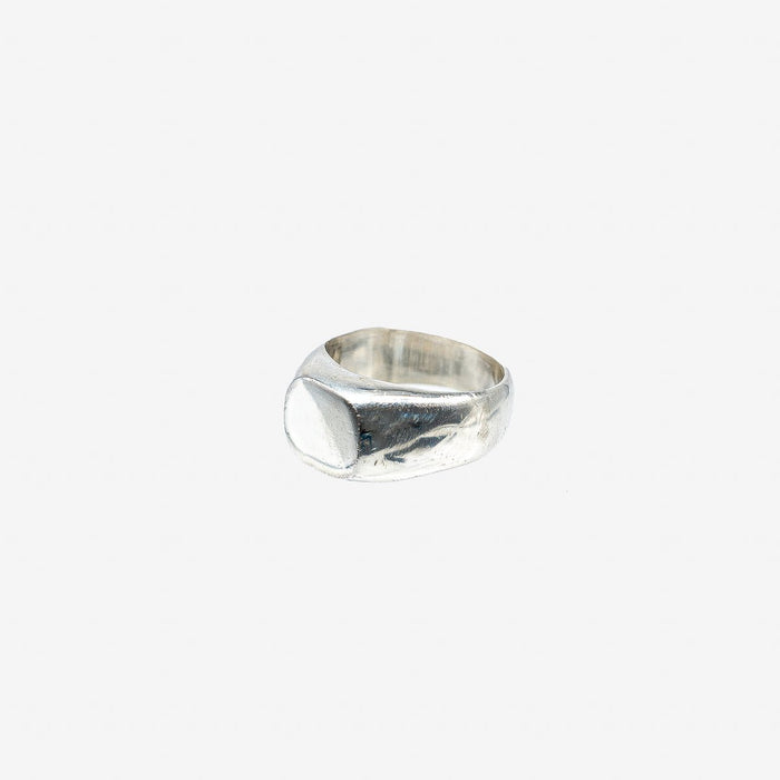 Minimalist hammered silver signet ring on white background from Iron Shop Provisions