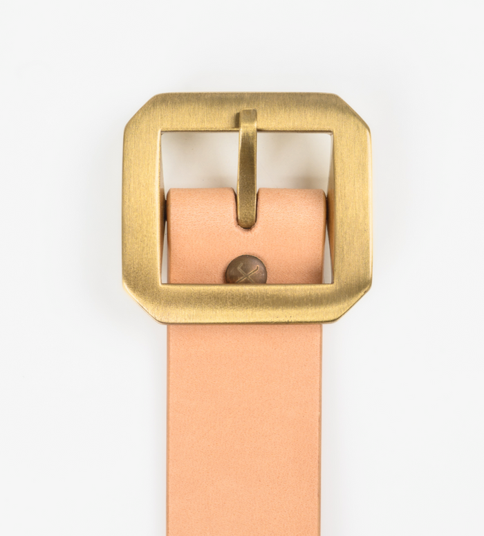 Tan leather belt with a gold buckle on a white background
