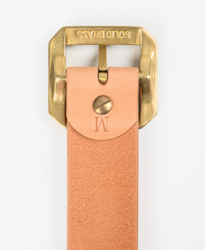 Brass buckle on a tan leather strap with 'Gold Brass' branding.
