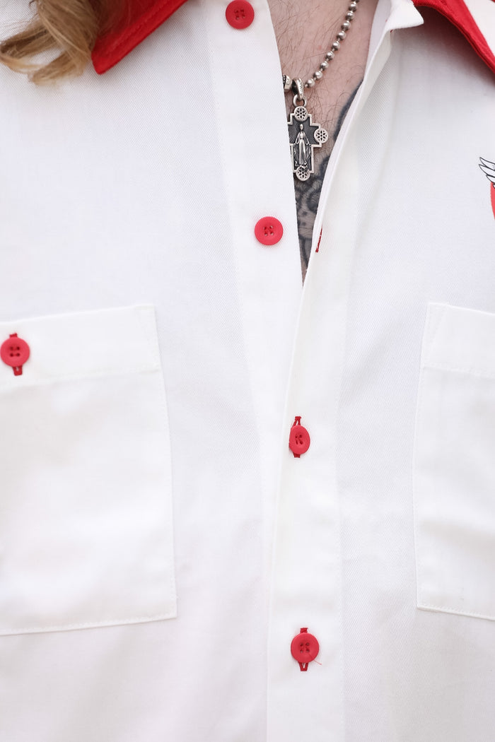 White shirt with red buttons on a white background