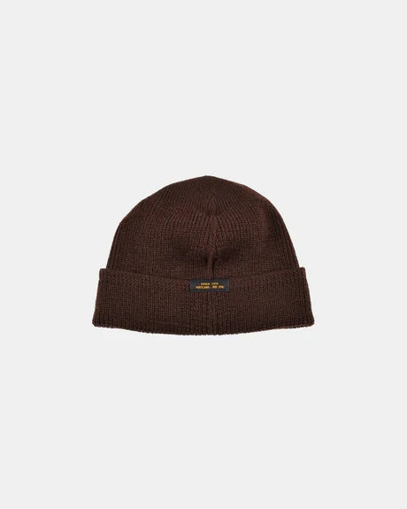Dehen 1920 wool knit watch cap in brown with folded cuff and small black label, isolated on light background